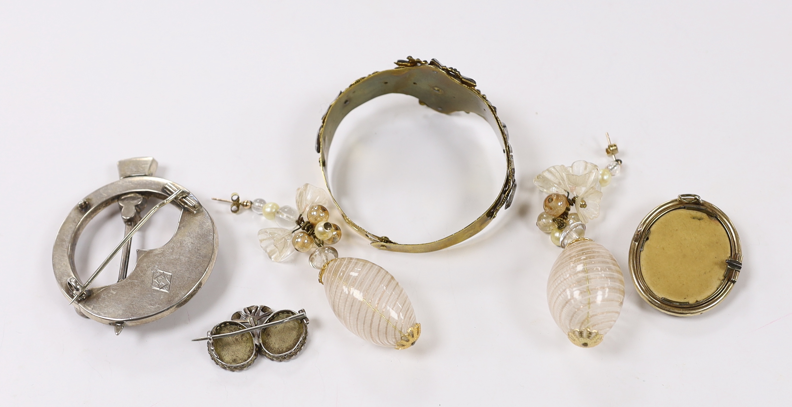 A small collection of assorted jewellery including a lava brooch, Scottish hardstone and cabochon set white metal brooch, pair of Venetian? glass drop earrings, two tone cut steel bangle and a white metal and simulated s